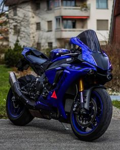 a blue motorcycle parked in front of a building