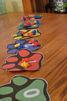 the wooden table is lined up with colorful paper cut outs