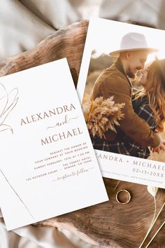 two wedding cards on top of a piece of wood