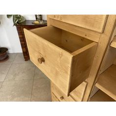 a close up of a drawer on a wooden cabinet