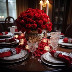 a table set with red roses in a vase and place settings for dinner or party