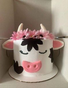 a cake decorated to look like a cow with horns and flowers on it's head