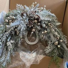 a box with a wreath and pine cones on it