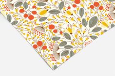 an orange, yellow and green floral pattern on a white background with red berries in the center