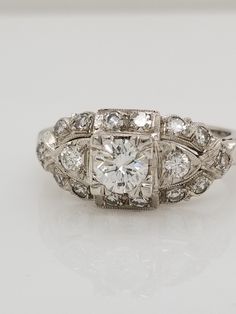 an antique style diamond ring with three stones