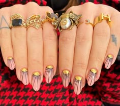 a close up of a person's hands with manies and rings on them