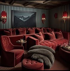 a room with red couches and chairs in it