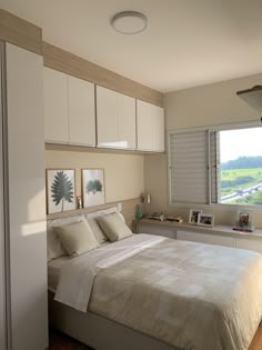 a bedroom with a large bed and white cabinets