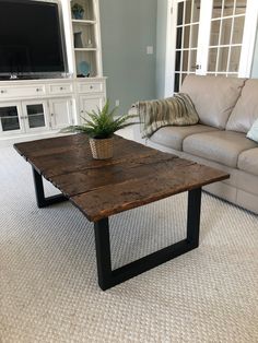 a living room with a couch, coffee table and television