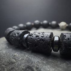 "Introducing our Men's Beaded Bracelet--a fusion of style and strength. Crafted with 8mm Lava stones, this minimalist bracelet seamlessly combines fashion and emotional balance. The stretch cord ensures a comfortable fit, while 925 sterling silver detail add a touch of sophistication to this versatile piece. Embrace the grounding energy of the Lava stone, making it more than just a fashion statement. This isn't just a men's silver bracelet; it's a symbol of resilience and style. Wear it as a roo Grounding Energy, Chakra Racine, Lava Stone Bracelet, Mens Bracelet Silver, Hematite Stone, Chakra Bracelet, Emotional Balance, Lava Rock, Mens Beaded Bracelets