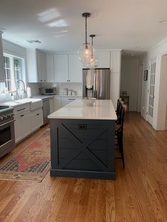 a large kitchen with an island in the middle