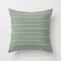 a green pillow with white dots on it