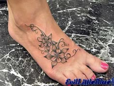 a foot with a flower tattoo on it