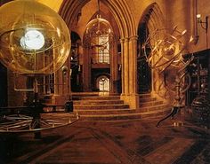 an old building with some big shiny balls in it's center and stairs leading up to the entrance