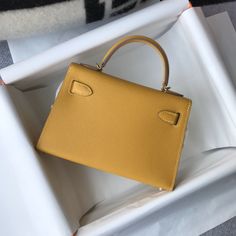 Description HRMS Kelly 19 Yellow With Gold Toned Hardware Bag For Women, Handbags, Shoulder Bags 7.5in/19cm Rep 1:1 Size: 19 x 11.5 x 5.5 cm / 7.5 x 4.5 x 2.2 inches (Length x Height x Width) Hermès bags are considered the ultimate luxury item worldwide. Each piece is handcrafted with waitlists that can exceed a year or more. The streamlined and demure Kelly style is always in high demand, it is particularly lovely in this vibrant version with gold hardware. Epsom is textured with a wonderful gr Louis Vuitton Shirt, Chanel Shirt, Luxury Products, Hermes Bags, Evening Clutch Bag, Bag For Women, Bag Tags, Fun Bags, Luxury Items