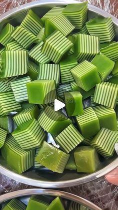 two bowls filled with green jello sitting on top of a table