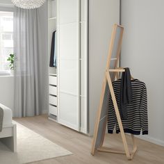 a clothes rack in the corner of a room