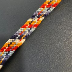 a close up of a colorful bracelet on a table