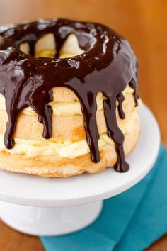 a chocolate drizzled bundt cake sitting on top of a white plate