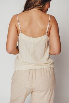 Whether you're on your way to sun-kissed beaches, picking up some things at the farmer's market, or stopping by your favorite coffee shop, you'll want to be wearing the Mello Tank. This is the easiest top we've curated this season -- it's breezy, chic, and completely feminine without any frills. Pair with denim, linen, or a slinky satin midi skirt. FIT: Runs true to size. MATERIAL: 55% Linen, 45% Rayon. GARMENT DETAILS: Lightweight camisole tank with square neckline, adjustable spaghetti straps, and relaxed fit. No lining. SIZE GUIDE: XS (0-2) / S (2-4) / M (6-8) / L (10-12) / XL (14-16) MODEL DETAILS: MISSES Mackenzie - Size S Heather - Size S Bust 34" 34" Waist 27.5" 27.5" Hips 40.5" 37.5" Height 5'7" 5'7" Summer Beachwear Camisole With Spaghetti Straps, Spaghetti Strap Camisole For Beachwear, Summer Beach Camisole With Adjustable Straps, Casual Summer Tops For Loungewear, Summer Beach Camisole With Spaghetti Straps, Summer Camisole With Spaghetti Straps For Beach Season, Summer Camisole With Adjustable Straps, White Linen Beachwear Tops, Chic Cotton Tank Top For Vacation