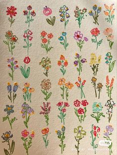 an embroidered wall hanging with flowers on it