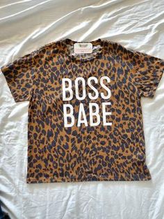 Boss Babe Leopard Graphic Tee – Mota Boutique Leopard Print T-shirt With Letter Print And Crew Neck, Trendy Leopard Print Graphic T-shirt, Casual Stretch Tiger Print Tops, Leopard Print Top With Letter Print For Summer, Leopard Print Graphic T-shirt For Summer, Summer Leopard Print Graphic T-shirt, Trendy Leopard Print T-shirt For Spring, Leopard Print Graphic Tee For Streetwear, Summer Leopard Print Tops With Graphic Print