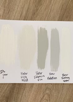 the different shades of paint on top of a wooden table with wood flooring in the background