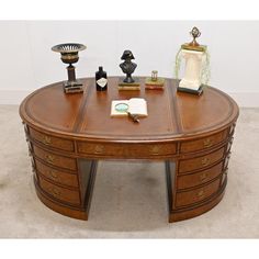 a wooden desk with drawers and books on it