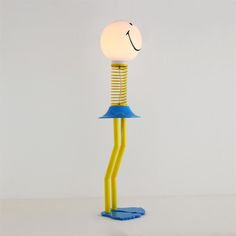 a yellow and blue lamp sitting on top of a table