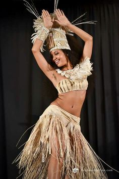 a woman in a hula skirt and headdress