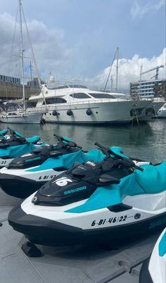 several jet skis lined up next to each other in front of a boat dock