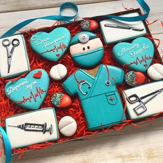 a box filled with decorated cookies in the shape of doctors