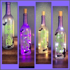 three wine bottles with lights in them and bats on the top, one is empty