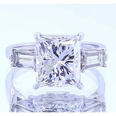 a princess cut diamond ring with baguetts on each side