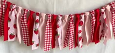 a red and white gingham banner with strawberries on it