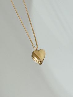 In my Heart Gold locket Keep your loved ones close to your heart in this mini heart locket made in 14k Gold filled. Small photos can be cut out and put inside the locket. Can be purchased with a very sleek 14k Gold filled box chain necklace that is perfect to wear as is. The chain is a tiny baby box chain, and it moves subtly on your neck to catch the light. Staple for everyday. + 14k Gold filled 25x20mm heart + 0.6mm chain + Comes in a box. + Please allow 3-5 business days to ship + Please note Gold Necklace Locket, Dainty Heart Pendant Locket Necklace With Charm, Heart Shaped Dainty Locket Necklace With Delicate Chain, Dainty Double Heart Locket Necklace With Charm, Dainty Heart Locket Necklace With Charm, Dainty Heart Locket Necklace With Delicate Chain, Dainty Double Heart Locket Necklace, Gold Dainty Locket Necklace With Heart Charm, Dainty Gold Locket Necklace With Heart Charm