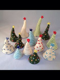 a group of ceramic christmas trees sitting next to each other