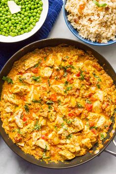 chicken curry in a skillet with peas and rice on the side text reads quick chicken curry