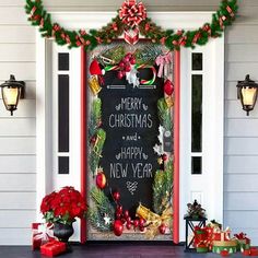 a decorated front door with christmas decorations and presents