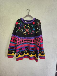 Vintage 1990's handknit pullover sweater by Casual Corner. Extremely detailed knit sweater with floral designs. Fabric is 55% Ramie, 45% cotton. Note: there are some small spots of what appears to be glitter glue, as shown in the photos. Due to the busy nature of the colors and design, it is not immediately obvious. All photos should be considered part of the description.  Measurements are approximate.  Width: 21" Length: 28" Sleeves from shoulder: 21" 90s Style Long Sleeve Spring Sweater, Fall Knit Patterns With Crew Neck, Vintage Winter Floral Print Tops, Vintage Floral Print Winter Tops, Fitted Bohemian Sweater With Crew Neck, Fitted Bohemian Crew Neck Sweater, Bohemian Floral Print Winter Sweater, Casual Multicolor Embroidered Sweater, Bohemian Fair Isle Sweater For Spring