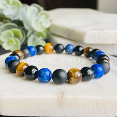 Black Tourmaline, Lapis lazuli, Matte Onyx and Tigers Eye Bracelet Handmade stretch bracelet beaded with Genuine High Quality 8mm Semi-Precious Gemstone Beads Very Strong Stretch Cord ★ Genuine Semi-Precious Gemstones ☆ Black Tourmaline ☆ Lapis Lazuli ☆ Tigers Eye ☆Matte Onyx * Lapis quickly releases stress, allowing for peace and serenity. * Tiger's Eye symbolizes the tiger's strength, bravery, and courage. * Matte Black onyx crystals can be used for grounding, protection, and self-control, and Tigers Eye Bracelet, Black Tourmaline Bracelet, Onyx Crystal, Tourmaline Bracelet, Men Bracelet, Tiger Eye Bracelet, Crystal Healing Bracelets, Tourmaline Beads, Mala Bracelet