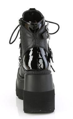 Shake it vampire style with the SHAKER-66 ankle boots! These baddies feature contrasting patent deets and fishnet-look panels, bat buckled straps, a horseshoe piercing, an O ring on the tongue and removable charms on the straps. Slip in and out in a snap with an inner zip and adjustable lace ups. Perfect for bringing your coven to the club! The Shaker series features a 4 1/2 inch platform wedge. Material: 100% vegan PU. US women's sizing-refer to size chart for more info. Punk Patent Leather Platform Boots, Gothic Platform Boots With Pointed Toe, Gothic Platform Ankle Boots With Metal Feet, Gothic Ankle Platform Boots With Metal Feet, Horseshoe Piercing, Vampire Style, Punk Festival, Black Bat, Shake It