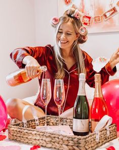 a woman is pouring champagne into wine glasses