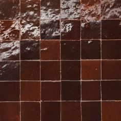 a tile wall with brown and white tiles on it