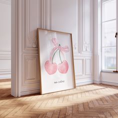 an empty room with a framed poster on the floor