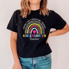 a woman wearing a black t - shirt with the words kindergarten on it