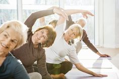 group of older women doing yoga together