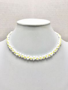 DESCRIPTION:  This necklace features a daisy chain that was hand-beaded using hundreds of tiny seed beads. Each flower was lovingly hand-stitched together using a needle and non-stretchy nylon thread. The clasp on the necklace is a silver-plated lobster claw clasp (See the sixth photo).  Unlike traditional daisy chains mad with real flowers, this daisy chain will never wilt! This daisy chain is so adorable, lightweight and comfortable to wear. The choker length makes the necklace lay so beautifu White Flower Necklace With Colorful Beads For Summer, White Summer Flower Necklace With Colorful Beads, Summer White Flower Necklace With Colorful Beads, Trendy White Flower Necklace For Summer, Handmade White Beaded Necklaces For Spring, White Beaded Flower Necklace For Summer, Handmade White Beaded Necklace For Spring, Summer White Beaded Flower Necklace, Adjustable White Flower Necklace For Summer