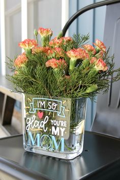 a vase filled with flowers sitting on top of a black table next to a chair