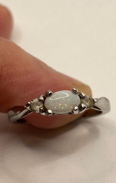 Vintage White Fire Opal Ring 925 Sterling Silver Rhodium https://www.etsy.com/listing/1208388072/vintage-white-fire-opal-ring-925 Classic White Opal Ring With Birthstone, Classic White Opal Birthstone Ring, White Oval Opal Ring Hallmarked, Oval White Opal Ring Hallmarked, Silver Multi-stone Opal Ring For Promise, White Multi-stone Moonstone Ring For Formal Occasions, Formal White Multi-stone Moonstone Ring, White Sterling Silver Opal Ring Stamped 925, Silver Three Stone Opal Ring For Anniversary